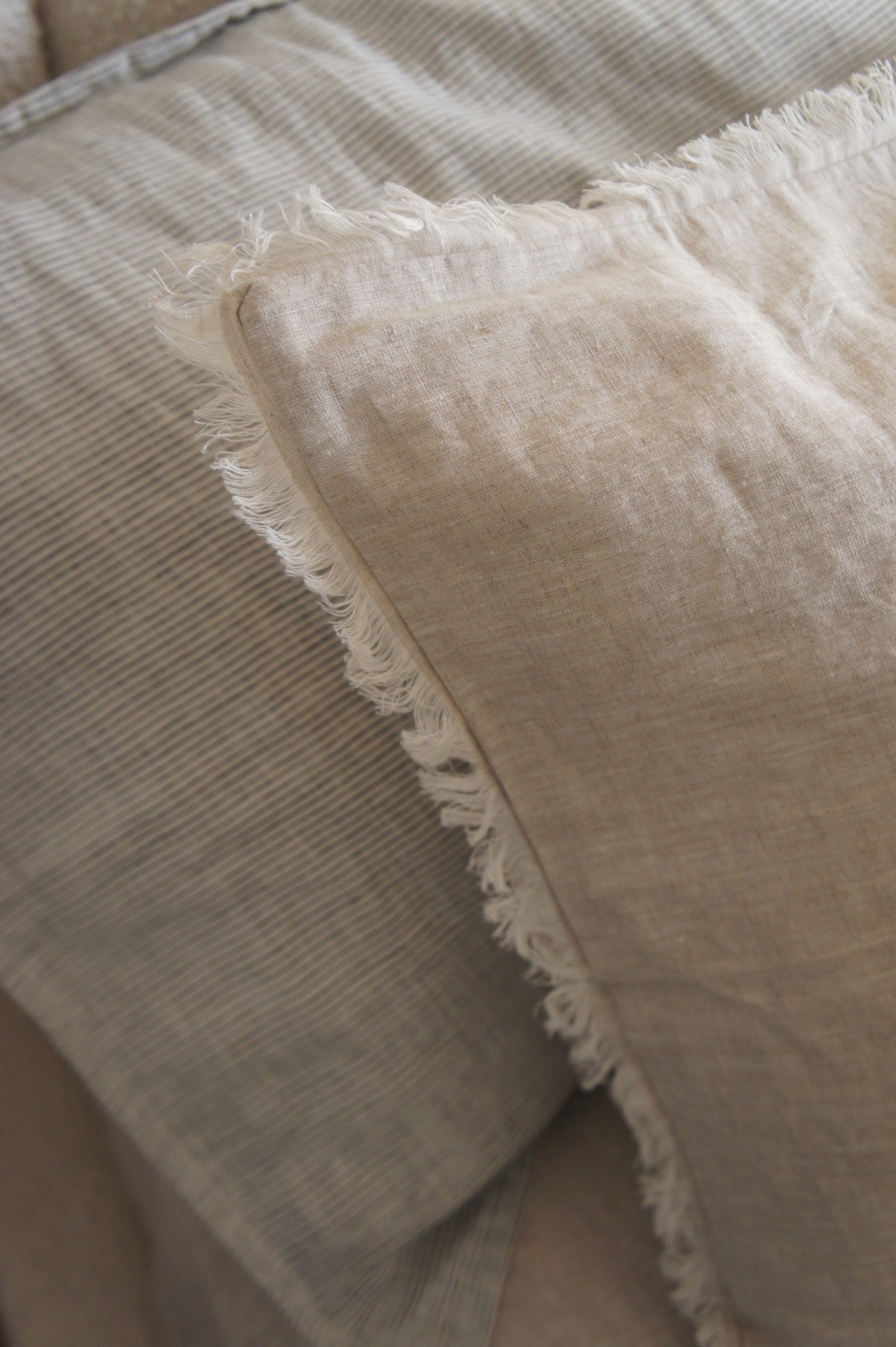 Set of two SOL Linen Sable frayed linen pillowcases for bedding, featuring a soft, natural texture and casual frayed edges.