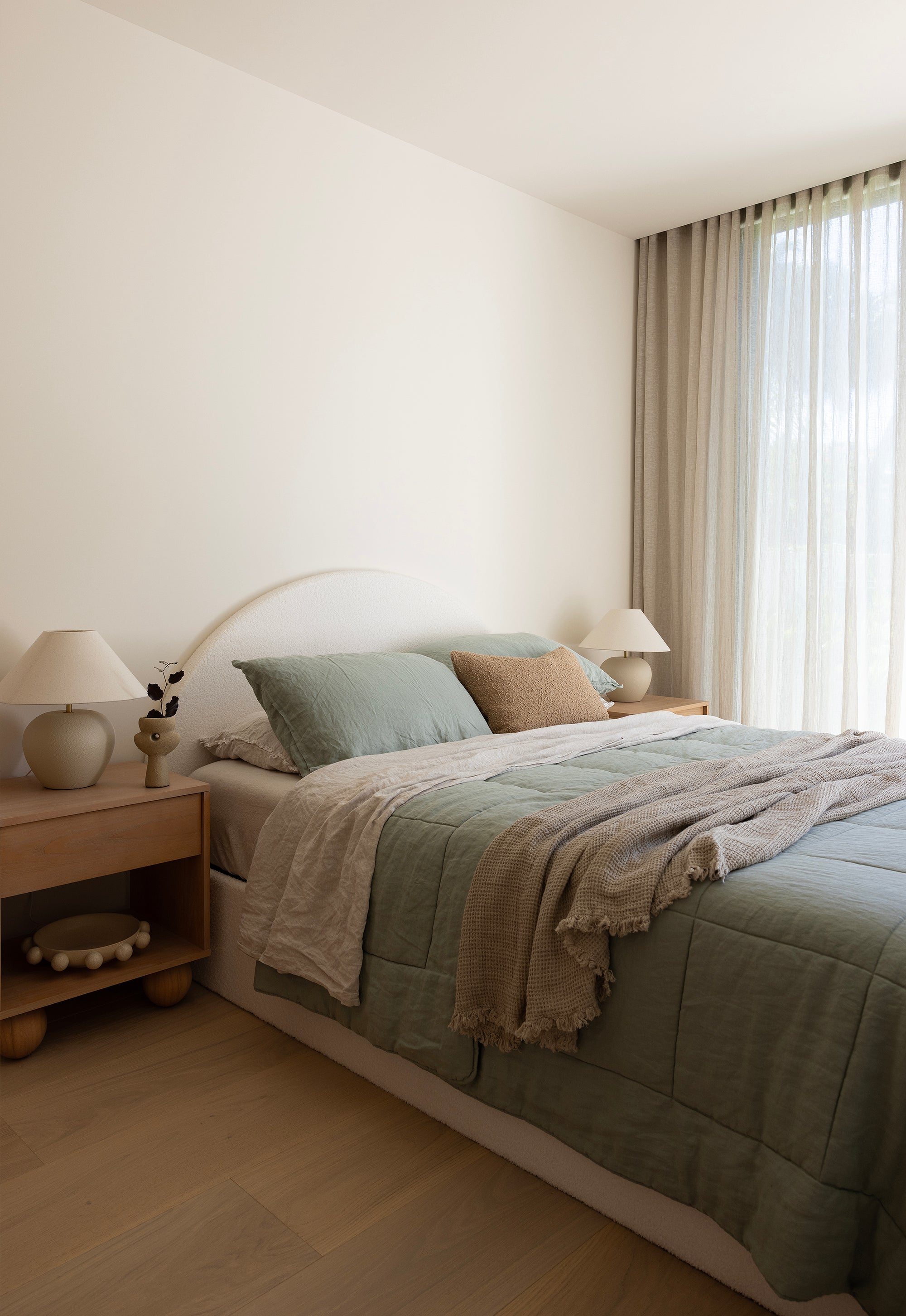 SOL Linen Sea Mist linen quilted coverlet draped over a bed with a textured, soft fabric in a calming sea mist color.