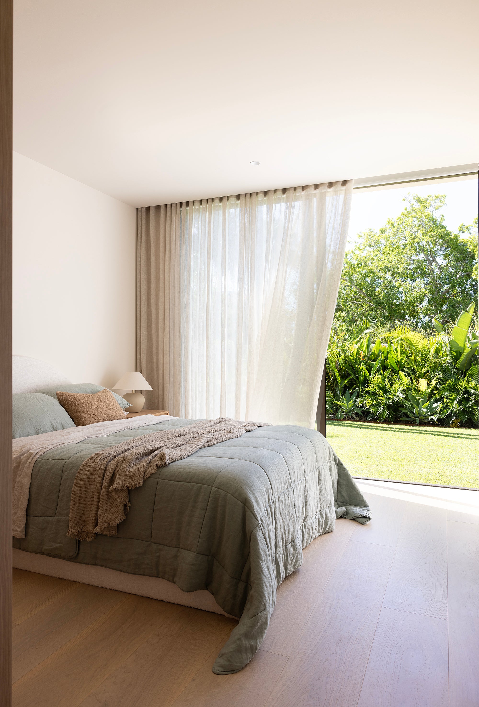 SOL Linen Sea Mist linen quilted coverlet displayed on a bed with a serene, textured design in a cozy bedroom setting