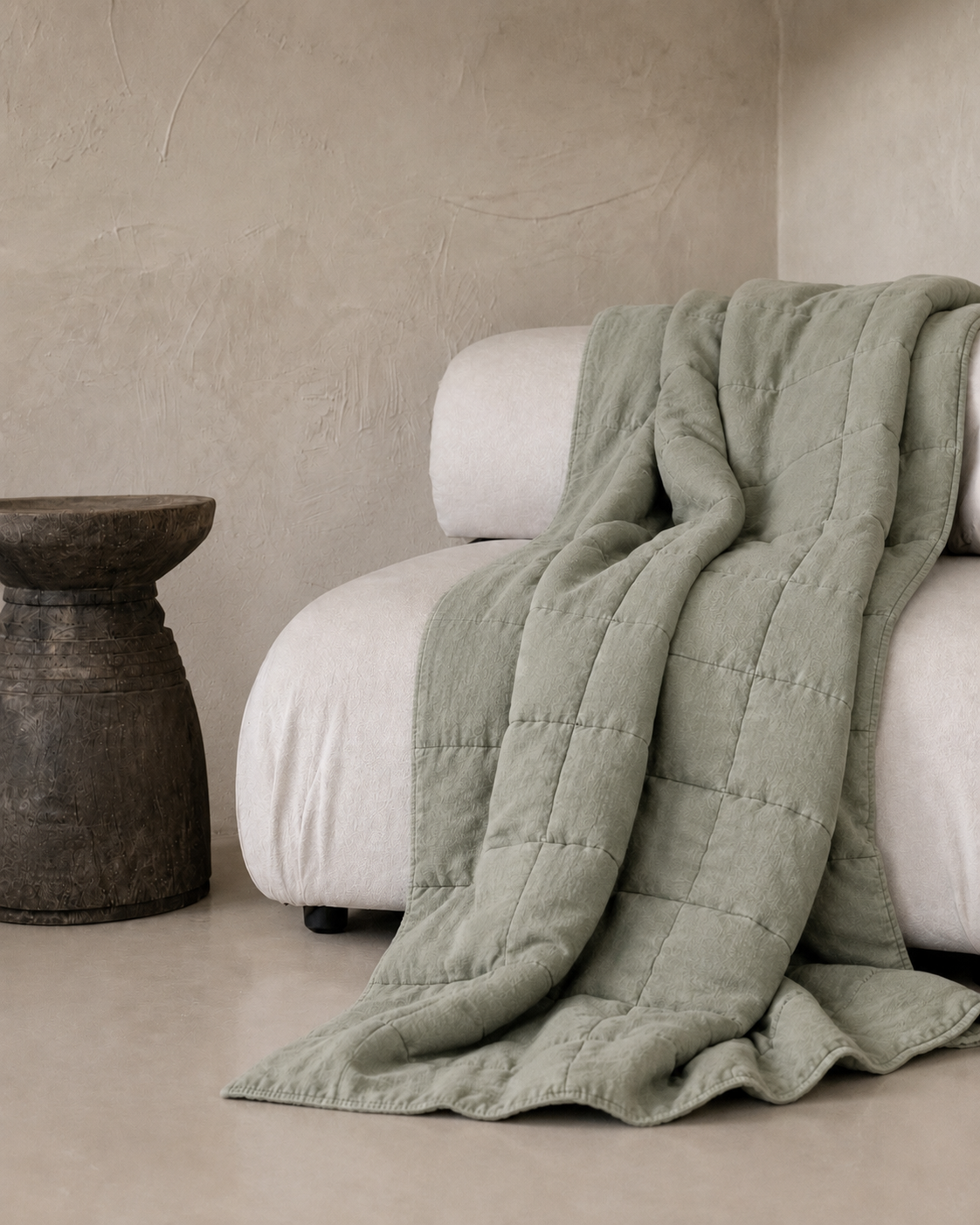 SOL Linen Sea Mist quilted coverlet draped over a bed, showcasing its soft linen fabric and elegant quilted texture.