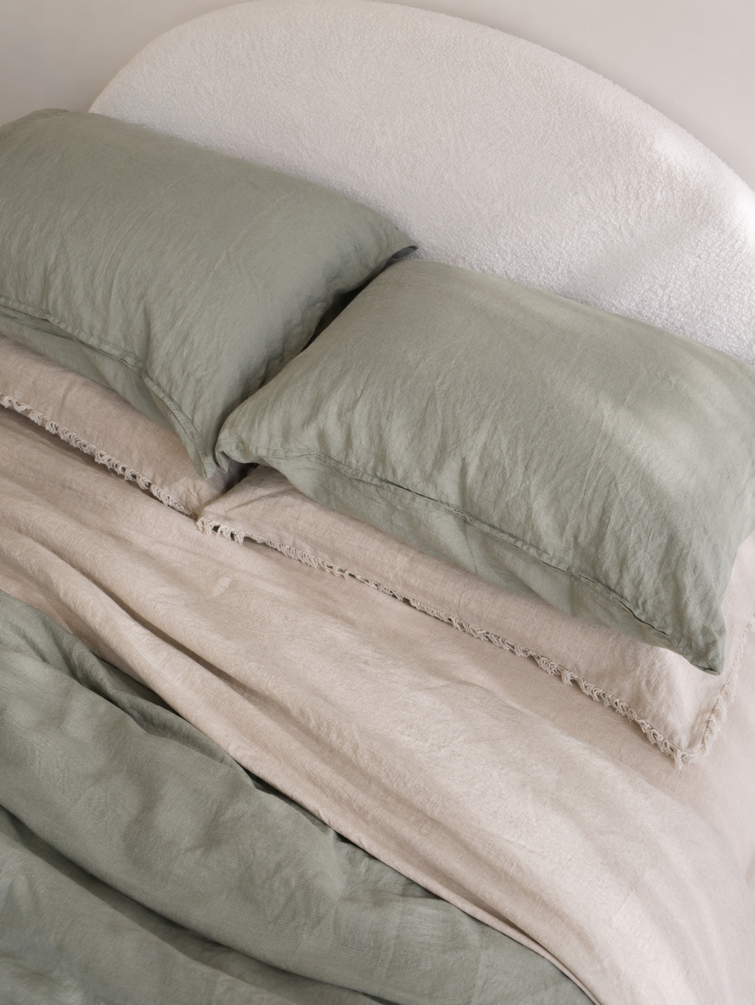 SOL Linen Sea Mist linen duvet cover displayed on a bed, showcasing its soft, textured fabric in a calming sea mist color.