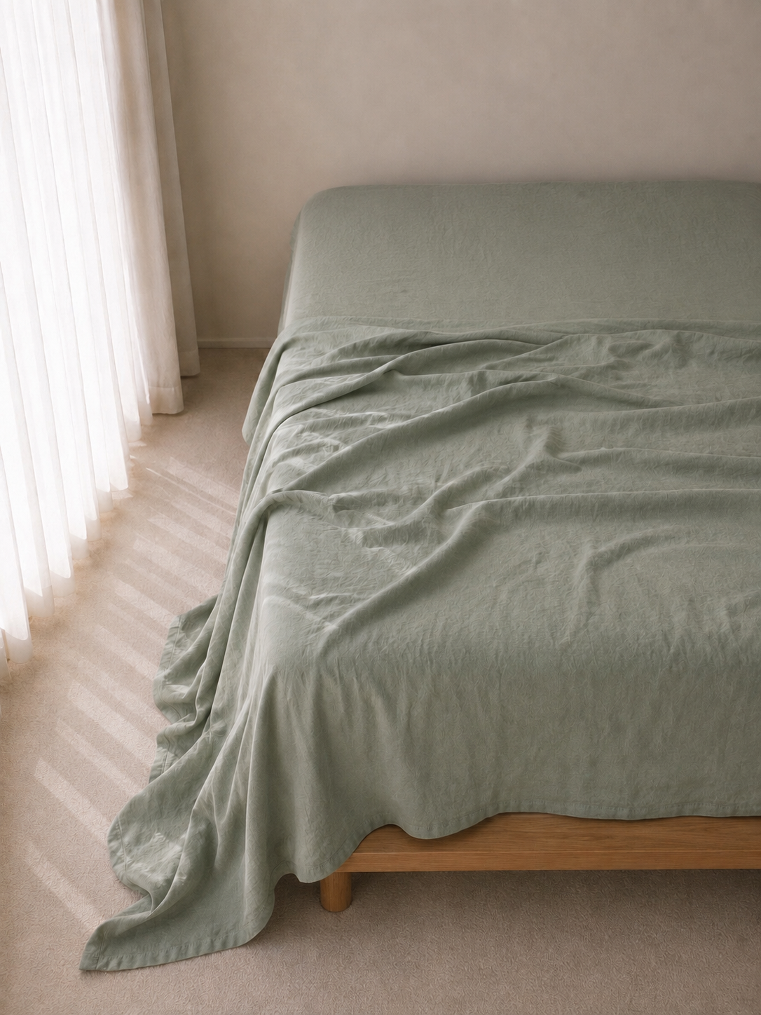 SOL Linen Sea Mist linen flat sheet for bedding, showing soft, textured sea mist-colored linen fabric laid out on a bed.