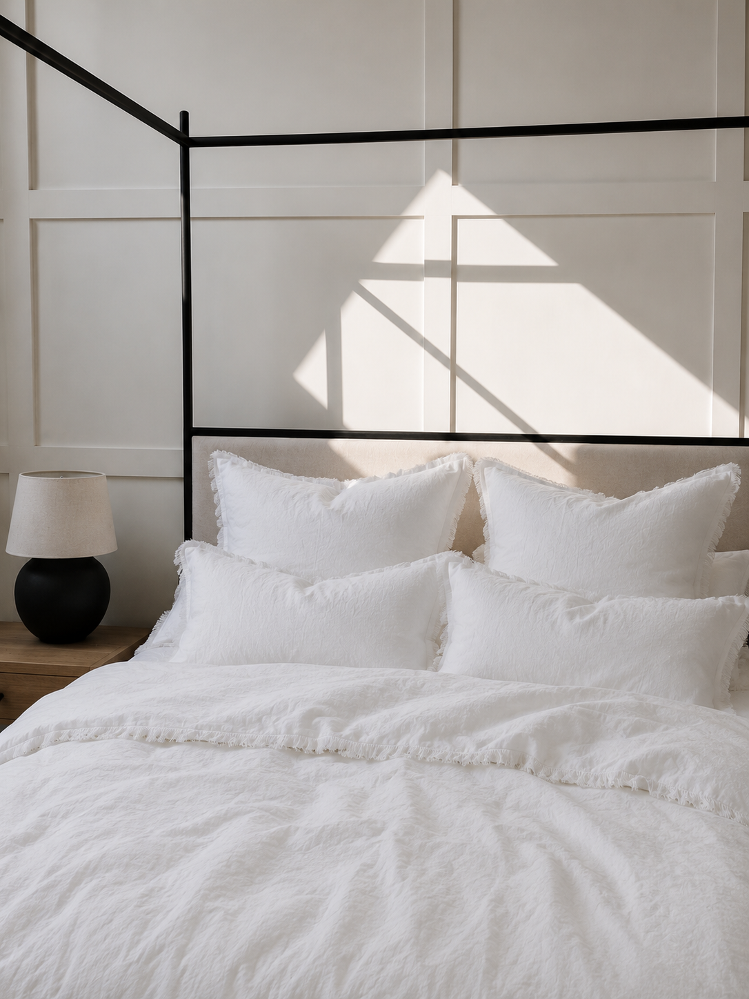 SOL Linen Whistler Frayed Linen Duvet Cover displayed on a bed with neutral bedding and decorative pillows in a cozy bedroom setting.