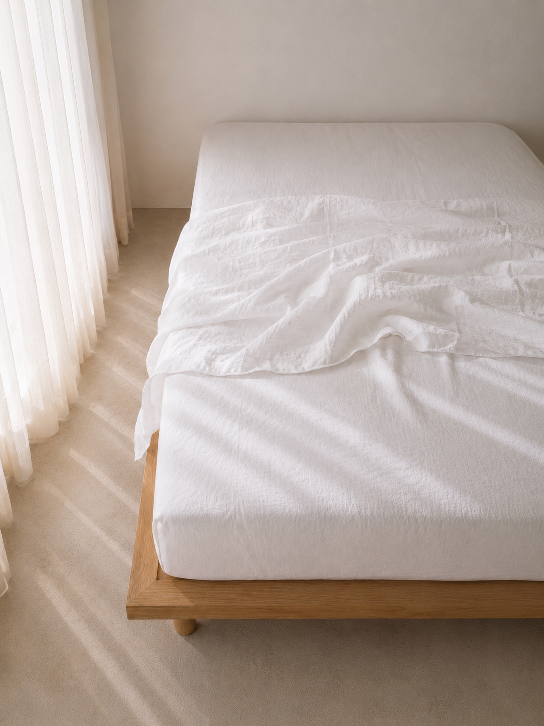 SOL Linen Whistler fitted sheet in linen, showing a neatly made bed with the soft, textured fabric in a cozy bedroom setting.