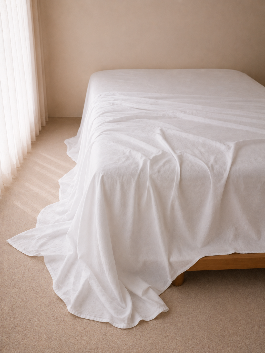 SOL Linen Whistler Linen fitted sheet in natural, textured linen fabric, shown on a neatly made bed in a cozy bedroom setting.